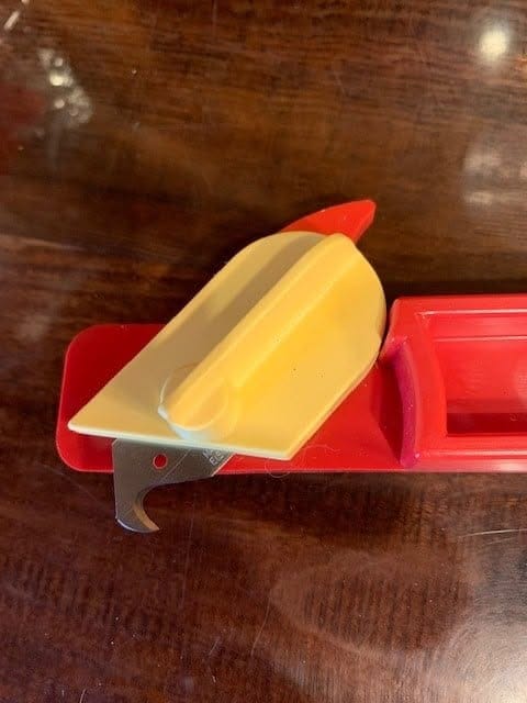 Close-up of the Fine Twine Cutter blade and yellow guard
